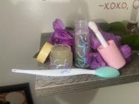 a shelf with cosmetics and a brush on it